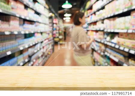 Empty wood table top with supermarket blurred background for product display Empty wood table top with supermarket blurred background for product display 117991714