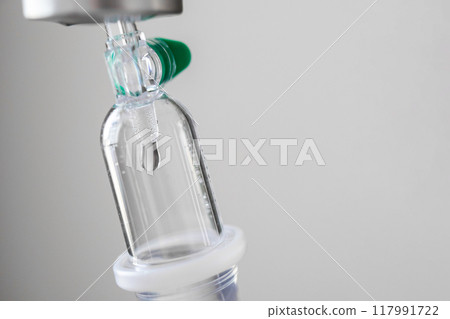Close up medical intravenous IV drip in hospital background 117991722