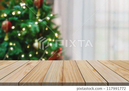 Empty table top with blurred Christmas tree with bokeh light background Empty table top with blurred Christmas tree with bokeh light background 117991772