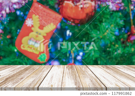 Empty wood table top with blur Christmas tree with bokeh light background Empty wood table top with blur Christmas tree with bokeh light background 117991862