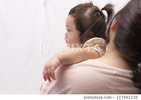 [Baby with twin tails being held by grandmother] 117992156