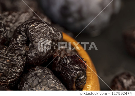 ripe purple plums and dried plums 117992474