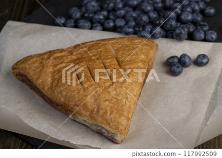 close-up of a blueberry stuffed bun with blueberries close-up of a blueberry stuffed bun with blueberries 117992509