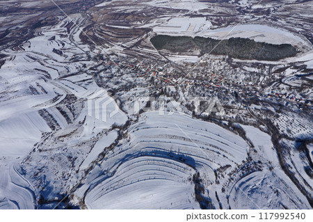 Aerial view of snow covered countryside hills and meadow 117992540