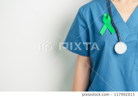 Doctor with green Ribbon for world Lymphoma Awareness September month, world Mental Health Day, Liver, Gallbladders, bile duct, cervical, kidney Cancer. Healthcare and world cancer day concept 117992813