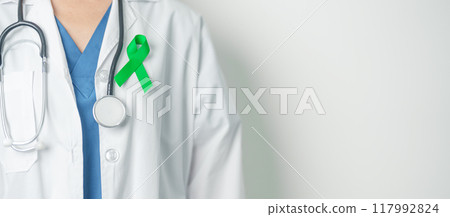 Doctor with green Ribbon for world Lymphoma Awareness September month, world Mental Health Day, Liver, Gallbladders, bile duct, cervical, kidney Cancer. Healthcare and world cancer day concept Doctor with green Ribbon for world Lymphoma Awareness September month, world Mental Health Day, Liver, Gallbladders, bile duct, cervical, kidney Cancer. Healthcare and world cancer day concept 117992824