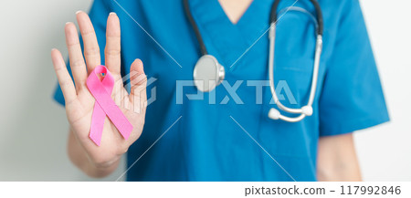 Pink October Breast Cancer Awareness month, woman doctor with pink Ribbon in hospital for support people life and illness. National cancer survivors month, Mother and World cancer day concept 117992846
