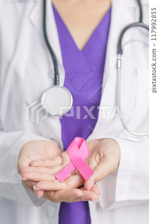 Pink October Breast Cancer Awareness month, woman doctor with pink Ribbon in hospital for support people life and illness. National cancer survivors month, Mother and World cancer day concept 117992855