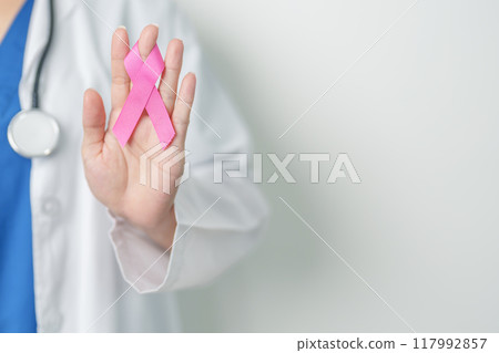 Pink October Breast Cancer Awareness month, woman doctor with pink Ribbon in hospital for support people life and illness. National cancer survivors month, Mother and World cancer day concept Pink October Breast Cancer Awareness month, woman doctor with pink Ribbon in hospital for support people life and illness. National cancer survivors month, Mother and World cancer day concept 117992857