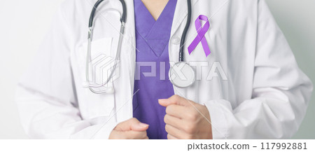 Doctor holding purple Ribbon for Violence, Pancreatic, Esophageal, Testicular cancer, Alzheimer, epilepsy, lupus, Sarcoidosis and Fibromyalgia. Awareness month and World cancer day concept 117992881