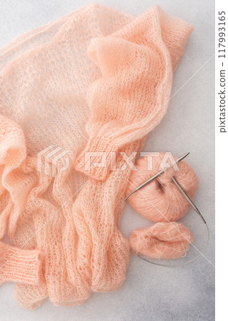 Home hobby, knitting a spider web sweater from pink threads Home hobby, knitting a spider web sweater from pink threads 117993165