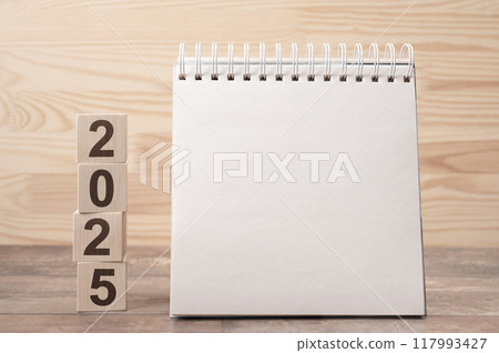 2025 mockup notepad. 2025 cubes wooden table background. New Year. plans for 2025, space for your text on notepad, mockup calendar 117993427