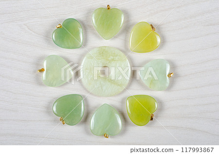 Green Dreams in Stone: Butter Jade's Versatility Shines in Artistic Layout of Donut Center and Radiating Heart-Shaped Pendants. Green Dreams in Stone: Butter Jade's Versatility Shines in Artistic Layout of Donut Center and Radiating Heart-Shaped Pendants. 117993867