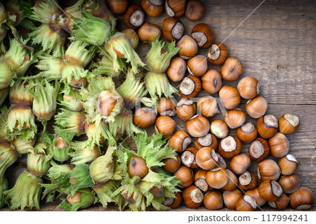 Fresh hazelnuts with green husks in wooden box 117994241