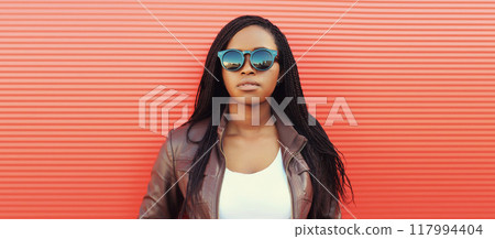 Fashionable young African woman in casual clothing, stylish modern black girl posing in the city Fashionable young African woman in casual clothing, stylish modern black girl posing in the city 117994404