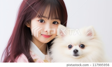 Happy asian woman and pet dog showing love and friendship on blurred white background 117995956