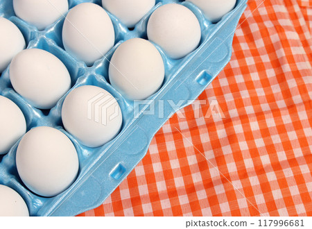 Carton of Eggs on Rustic Table With Checkered Table Cloth Carton of Eggs on Rustic Table With Checkered Table Cloth 117996681