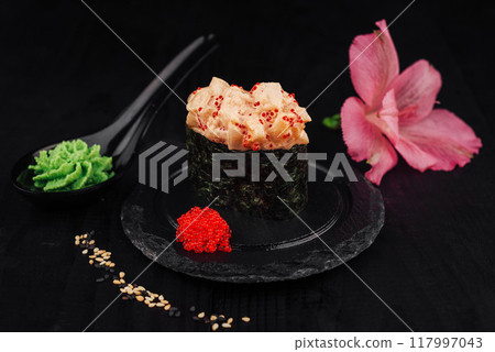 Gunkan sushi with spicy sauce, tobiko and wasabi on black background Gunkan sushi with spicy sauce, tobiko and wasabi on black background 117997043