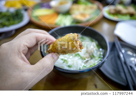 A table full of delicious Vietnamese Banh Xeo. A table full of delicious Vietnamese Banh Xeo. 117997244