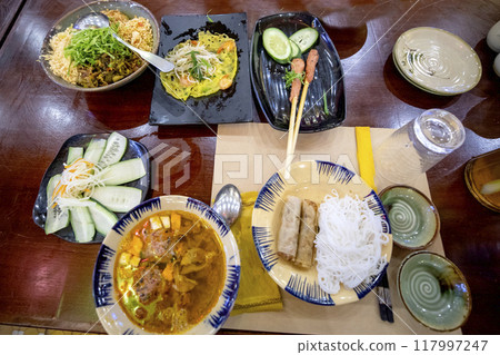 A table full of delicious Vietnamese Banh Xeo. A table full of delicious Vietnamese Banh Xeo. 117997247