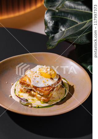 Delicious croque madame with fried egg served on plate 117997373