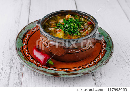 Delicious soup with vegetables and herbs served in rustic bowl 117998063