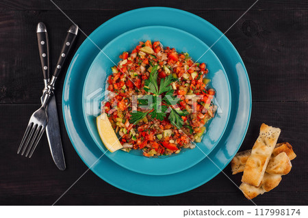 Turkish coban salad with lemon and pita bread on turquoise plate Turkish coban salad with lemon and pita bread on turquoise plate 117998174
