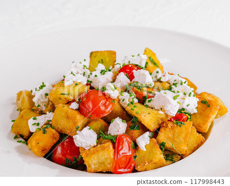Fresh homemade polenta with tomatoes and feta 117998443