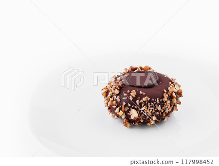 Gourmet chocolate nut tart on white background 117998452