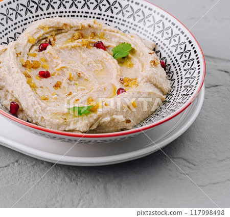 Classic hummus in a ceramic bowl Classic hummus in a ceramic bowl 117998498