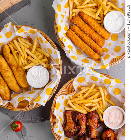 Assorted fast food platters on gray tabletop 117998519