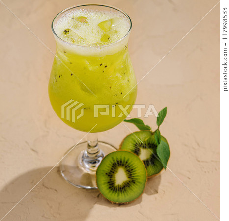Fresh kiwi cocktail on sandy background Fresh kiwi cocktail on sandy background 117998533