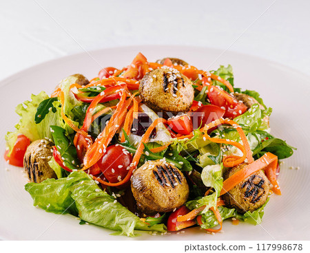 Grilled mushroom salad on white plate Grilled mushroom salad on white plate 117998678