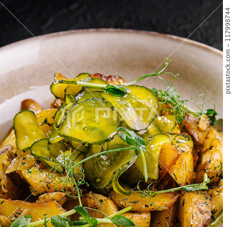 Gourmet roasted vegetable dish on dark background Gourmet roasted vegetable dish on dark background 117998744