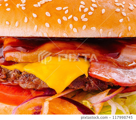 Delicious bacon cheeseburger close up background Delicious bacon cheeseburger close up background 117998745