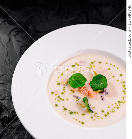 Gourmet creamy seafood soup in elegant white bowl Gourmet creamy seafood soup in elegant white bowl 117998746