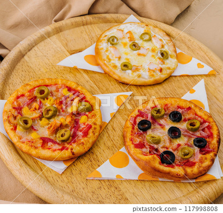 Delectable fast food feast on wooden table 117998808
