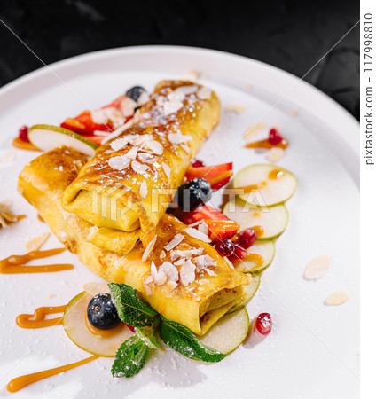 Gourmet sweet crepes on elegant white plate 117998810