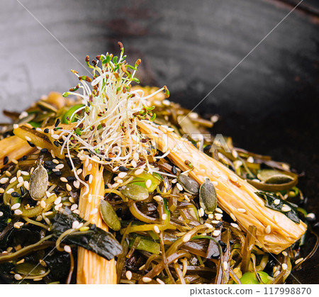 Vegan stir-fry noodles with sprouts and seeds 117998870
