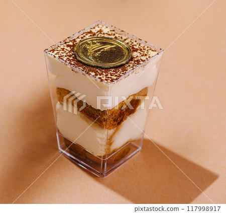 Elegant tiramisu dessert in glass cup 117998917