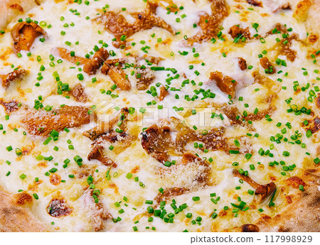 Freshly baked gourmet pizza on wooden board 117998929