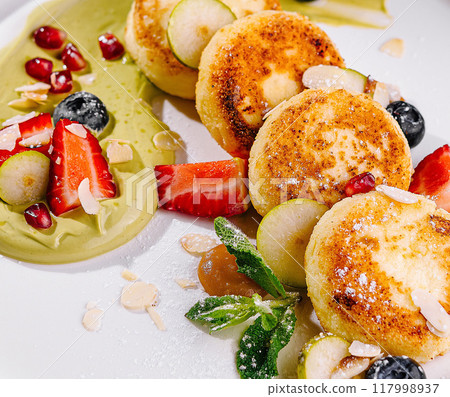 Gourmet cheese pancakes with fresh berries and sauce Gourmet cheese pancakes with fresh berries and sauce 117998937