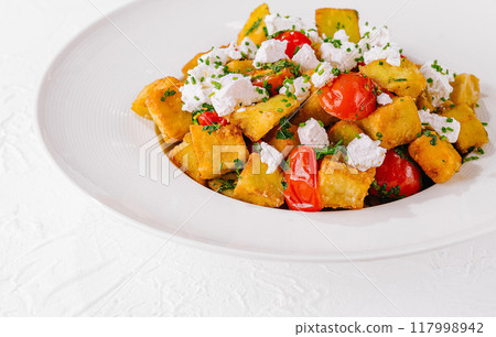 Fresh homemade polenta with tomatoes and feta Fresh homemade polenta with tomatoes and feta 117998942