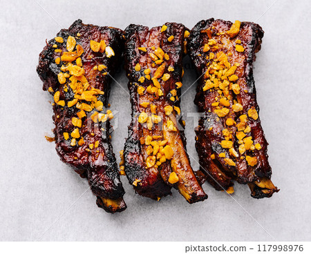 Gourmet glazed pork ribs on branded paper Gourmet glazed pork ribs on branded paper 117998976