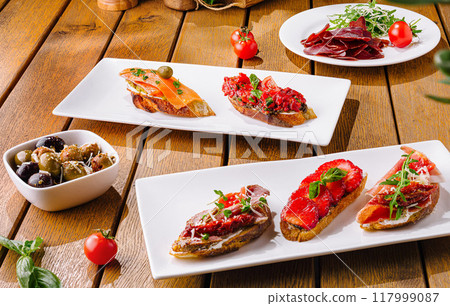 Gourmet bruschetta assortment on wooden table Gourmet bruschetta assortment on wooden table 117999087