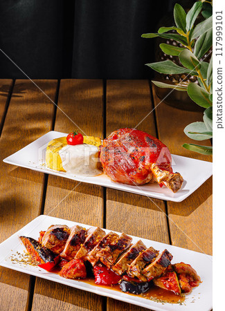 Gourmet grilled meat assortment on wooden table 117999101
