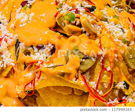 Loaded nachos with cheese and toppings 117999165