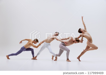 Dancers move in graceful sequence, emphasizing fluidity and connection as they stretch and reach towards each other, forming cohesive unit. 117999489
