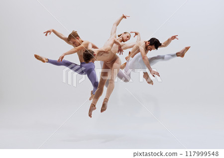 Dancers in mid-air, exercising control and precision, their leaps creating beautiful visual rhythm. against white studio background. Dancers in mid-air, exercising control and precision, their leaps creating beautiful visual rhythm. against white studio background. 117999548