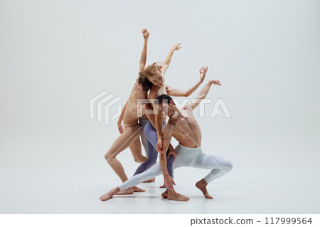 Dancers create intricate shape with fluid arm movements, demonstrating control and grace against white studio background. Dancers create intricate shape with fluid arm movements, demonstrating control and grace against white studio background. 117999564